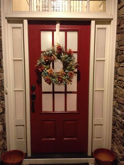 A Red Front Door With A Wreath On It