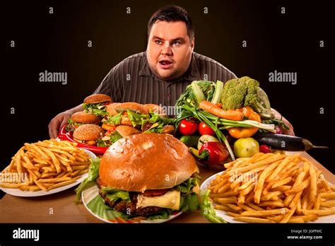 Diet Fat Man Makes Choice Between Healthy And Unhealthy Food Stock