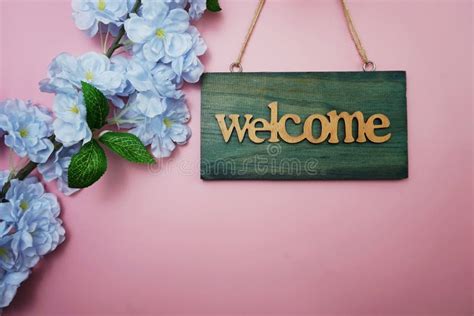 Welcome Sign And Flower Blooming Decoration On Pink Background Stock