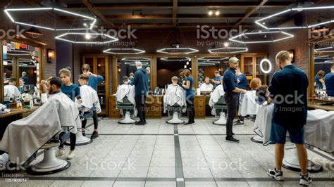 People At Barbershop Professional Barbers Serving Clients In The Modern