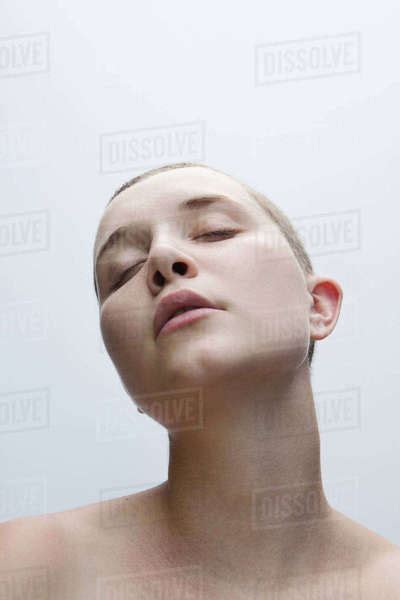 Woman With Shaved Head And Eyes Closed Stock Photo Dissolve