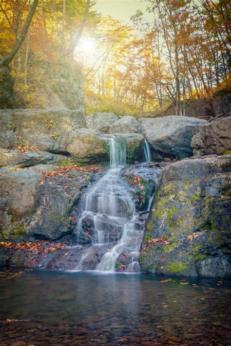Small Waterfalls Cascade In Autumn Season Colors In The