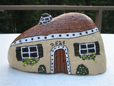 A Rock With A House Painted On It