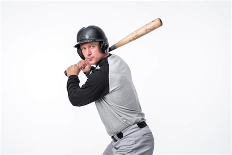 Baseball Player Posing In Helmet With Bat Free Photo