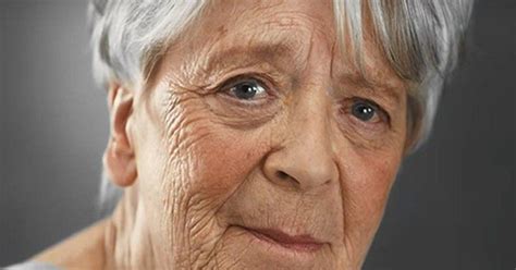 An Older Woman With Grey Hair And Blue Eyes