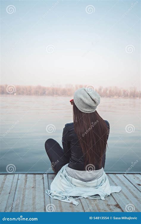 Girl Sitting On Pier And Looking At The River Stock Photo Image Of