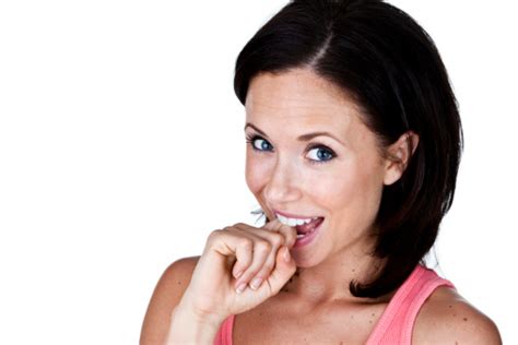 Happy Young Woman Biting Her Knuckle Stock Photo Download Image Now