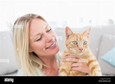 Young Woman Holding Cat At Home Stock Photo Alamy