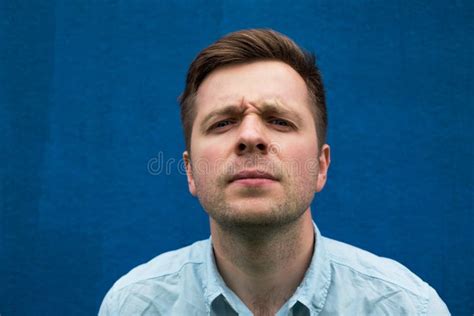 Portrait Of Young Caucasian Man Looking Perplexed In Camera Stock