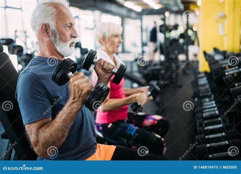 Fit Senior Sporty Couple Working Out Together At Gym Stock Image