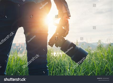 Young Asian Woman Photographer Holding Dslr Stock Photo 1820304467