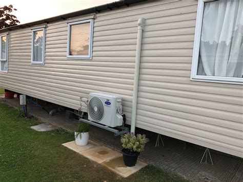 Air conditioning condenser units outside a building. Caravan Air Conditioning. - Stay cool this summer & warm ...