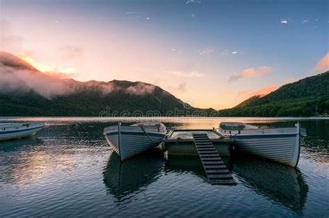 Mountain Lake Sunrise Landscape With Two Traditional Fishing Boats