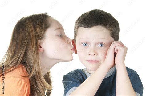 Young Girl Kissing Boy On Cheek Stock Photo Adobe Stock