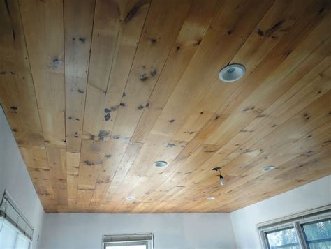 While my husband and son put the planks on the ceiling, i followed behind them with the painter's caulk and filled some of the bigger cracks and knot holes in the wood to give it a smoother, less rustic look. Pine Ceiling Planks Lowes | www.Gradschoolfairs.com