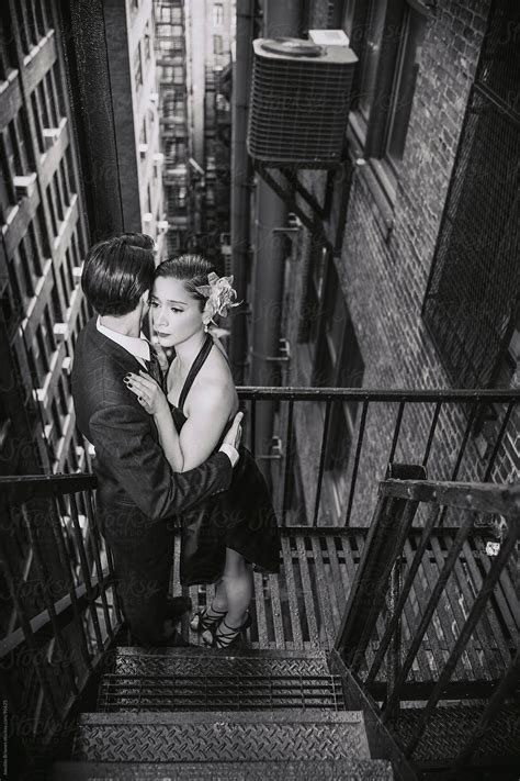 Hispanic Couple Dancing Tango In New York Fire Escape Stairs In Black