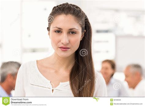Pretty Businesswoman In Front Of Her Colleagues Stock Image Image Of Brunette Dressed 58186329