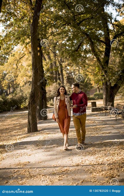 Young Couple Walking In The Autumn Park Stock Photo Image Of