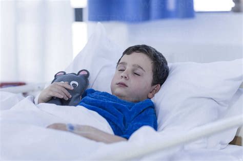 Portrait Of Little Boy Sleeping In A Hospital Bed Stock Photo