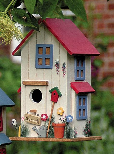Two Bird Houses Are Shown In Front Of Some Trees