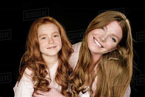 Beautiful Happy Redhead Mother And Daughter Embracing Isolated On Black