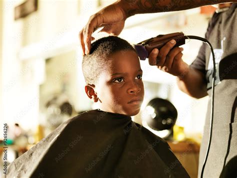 Little African Boy Getting His Hair Cut In Barber Shop Stock Photo