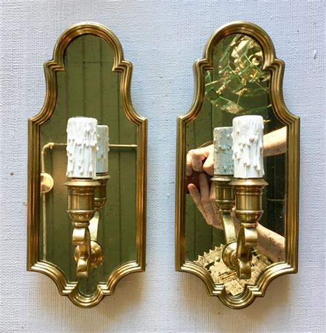 This wall sconce is made of a metal frame with glass holders included for the candles. Hollywood Regency Style Sussex Brass and Mirror Candle ...