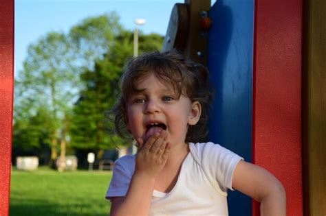 Premium Photo Girl Licking Palm While Playing On Playground