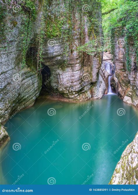 Mountain River And Waterfall With Clear Turquoise Water In A Stone