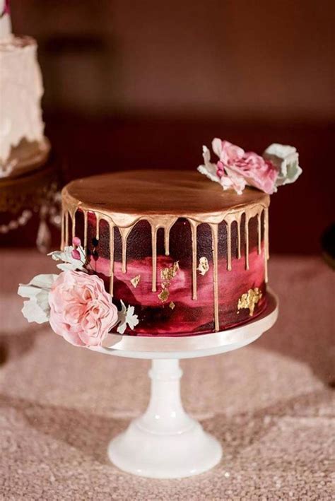 Burgundy Painted Wedding Cake With Gold Drip And Gold Leaf Topped With