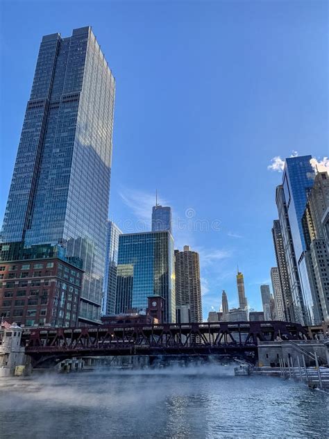 Portrait View Of The Chicago River As Steam Rises Up From Waters During