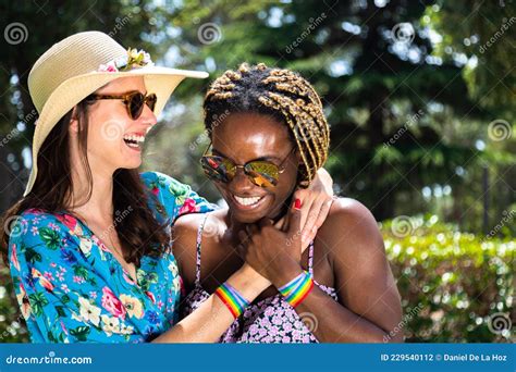 Young Multiracial Lesbian Couple Laugh Together During Vacations Stock