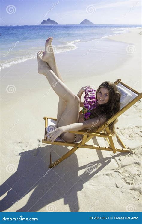 Girl In Bikini Sitting On A Beach Chair Royalty Free Stock Photography