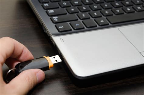 Hand Inserting Usb Flash Drive Into Laptop Computer Port Closeup Stock