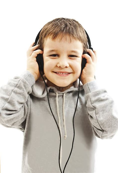 The Young Boy Is Smiling And Listening To Music Stock Image Image Of