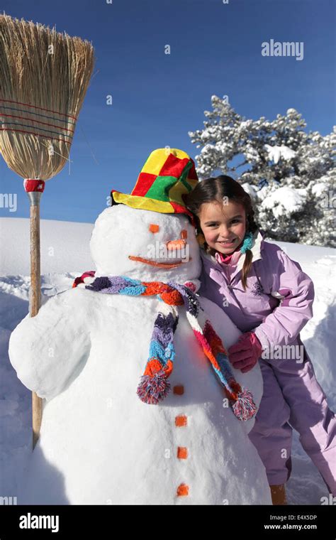 Little Girl With Snowman Stock Photo Alamy