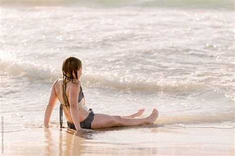 Pre Teen Girl Sitting At The Water S Edge At The Beach By Stocksy Contributor Angela Lumsden