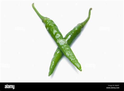 Close Up Of Two Green Chili Peppers In Crossed Shape Stock Photo Alamy