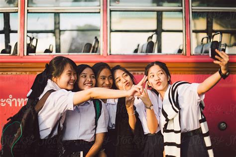 Thai School Girl Group Making Selfie Together At The Bus Stop