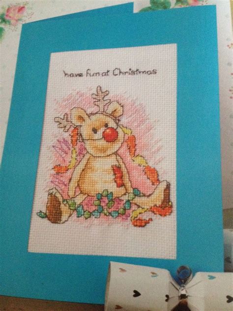 a cross stitch card with a teddy bear on it