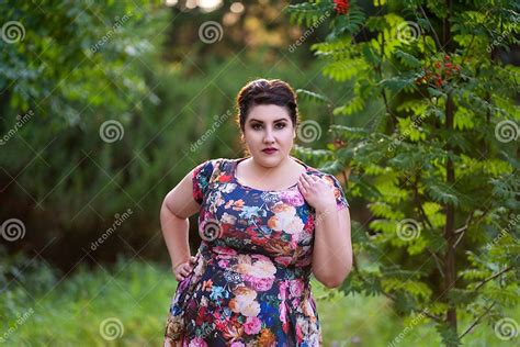 plus size model in floral dress outdoors beautiful fat woman with big breasts in nature stock