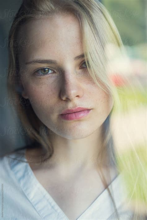 Face Of A Beautiful Young Girl Behind The Glass By Stocksy