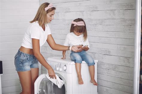 Madre E Hija En Un Baño Cerca De Lavar Mashine Foto Gratis