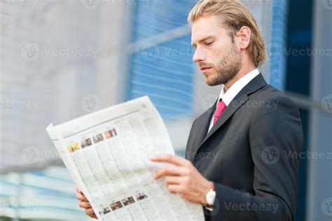 Handsome Businessman Reading A Newspaper 1112080 Stock Photo At Vecteezy