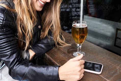 Blonde Having Beer In Bar Terrace By Stocksy Contributor Ivan Gener Stocksy