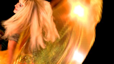 A Woman With Blonde Hair Is Spinning Around