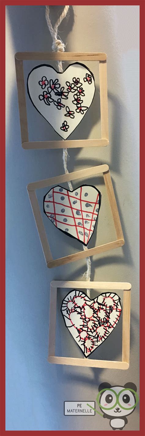 Three Wooden Frames With Painted Hearts Hanging From The Side And An
