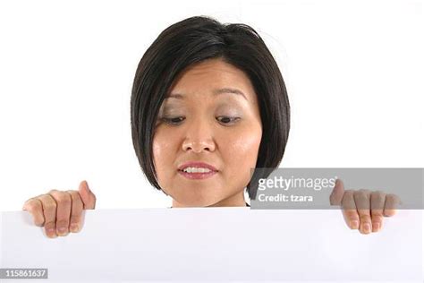 person peeking over wall photos and premium high res pictures getty images