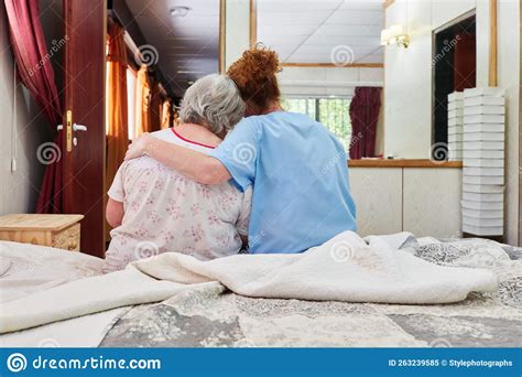 elderly nurse hugs and comforts sick senior woman stock image image of illness comfort 263239585