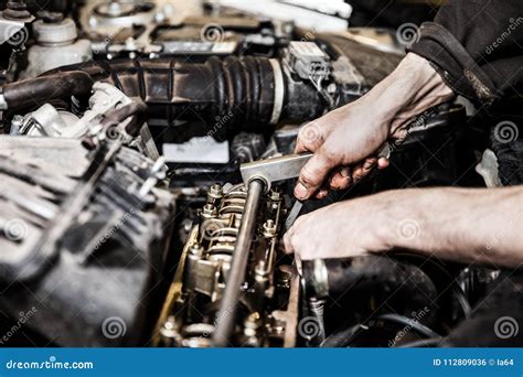 Automobile Service Worker Or Garage Mechanic Repairing Auto Car Engine